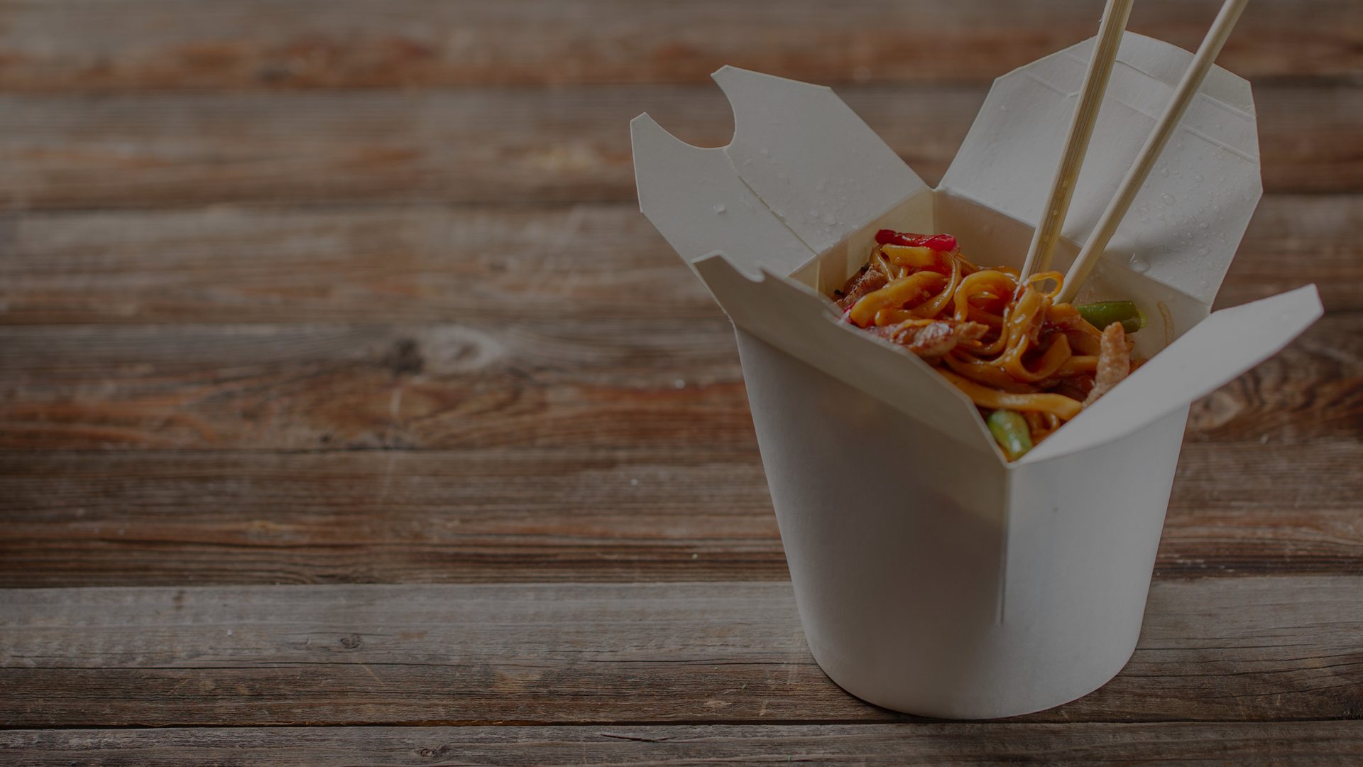 House of Thai noodles in a takeout box with chopsticks